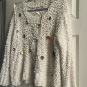 Cute sweater with colorful jewels and rips. Pair with a cute tank under. M/L